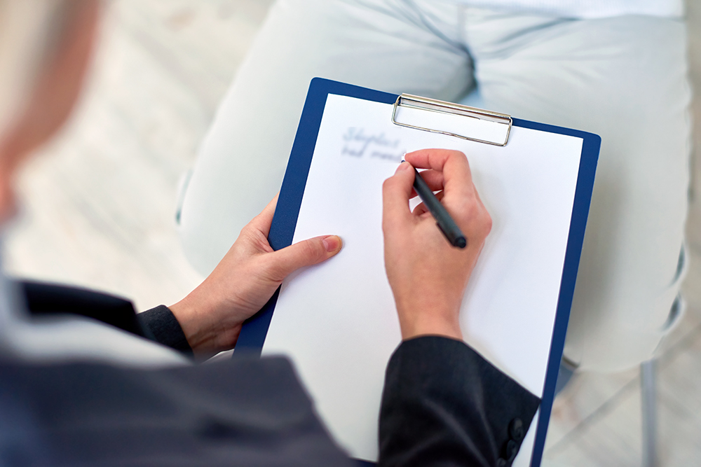 Crop therapist taking notes on meeting